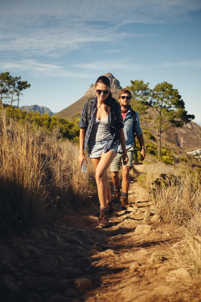 Hiker couple trekking together in countryside